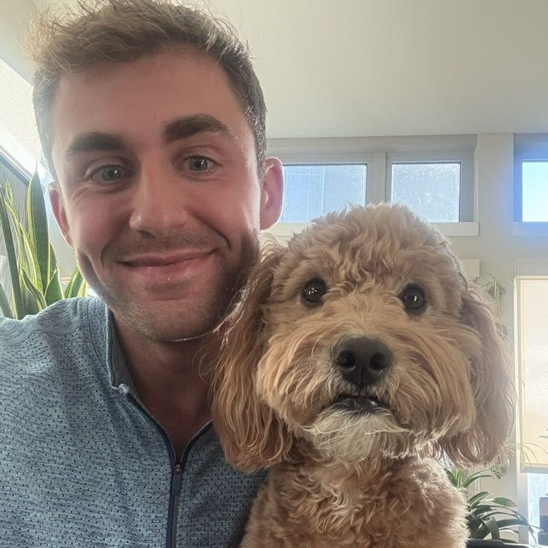 Daily photo from a past check-in: Brett taking a selfie with a very serious goldendoodle